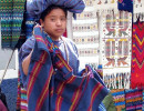 58 Woman offering textiles in the market place of Chichicastenango 800