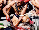 9 tribesman butchering a pig for the ceremony 800