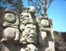 9 faces carved into the rocks at copan
