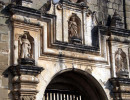 11 religious sculptures over an entrance of a ruined church in antigua
